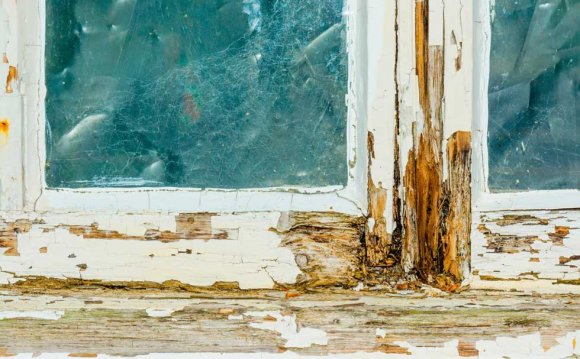 A decaying timber window frame