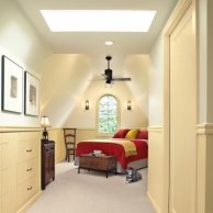 a ceiling fan installed in this refinished attic