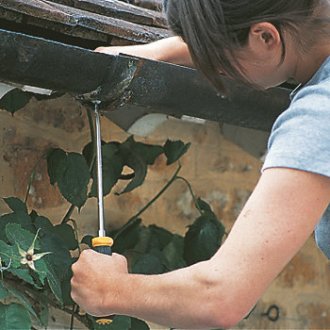 Lady repairing cast iron guttering