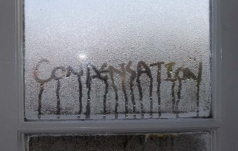 The word 'condensation' written in condensation on a window